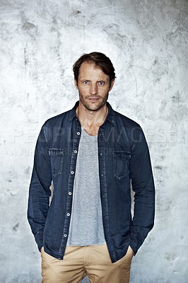 Buy stock photo Portrait of a mature man standing in front of a wall