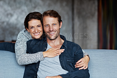 Buy stock photo Portrait of an affectionate mature couple in their living room