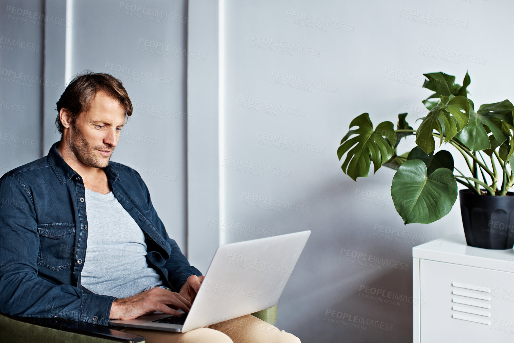 Buy stock photo Freelancer, laptop and typing with man on sofa in home for blog review, online update and editing report. Remote worker, writing draft and newsletter with person in living room in house for tech