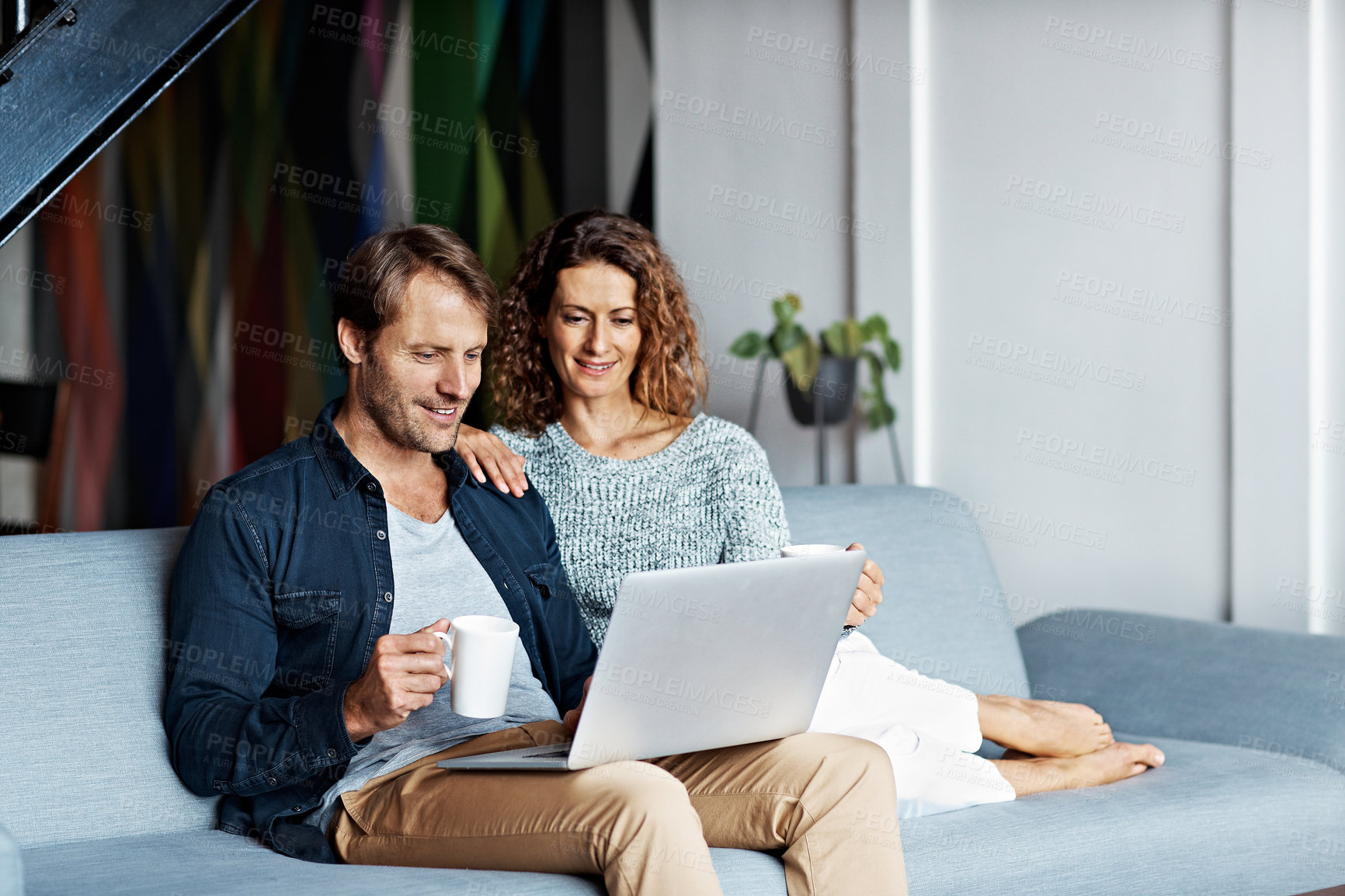 Buy stock photo Laptop, happy and coffee with couple on sofa in home for connection, social media post and bonding. Relax, smile and online news feed with man and woman in living room in house for drink and tech