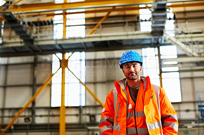 Buy stock photo Portrait of a man in workwear standing in a large industrial building