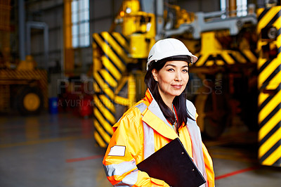 Buy stock photo Portrait of a woman in workwear standing in a large industrial building