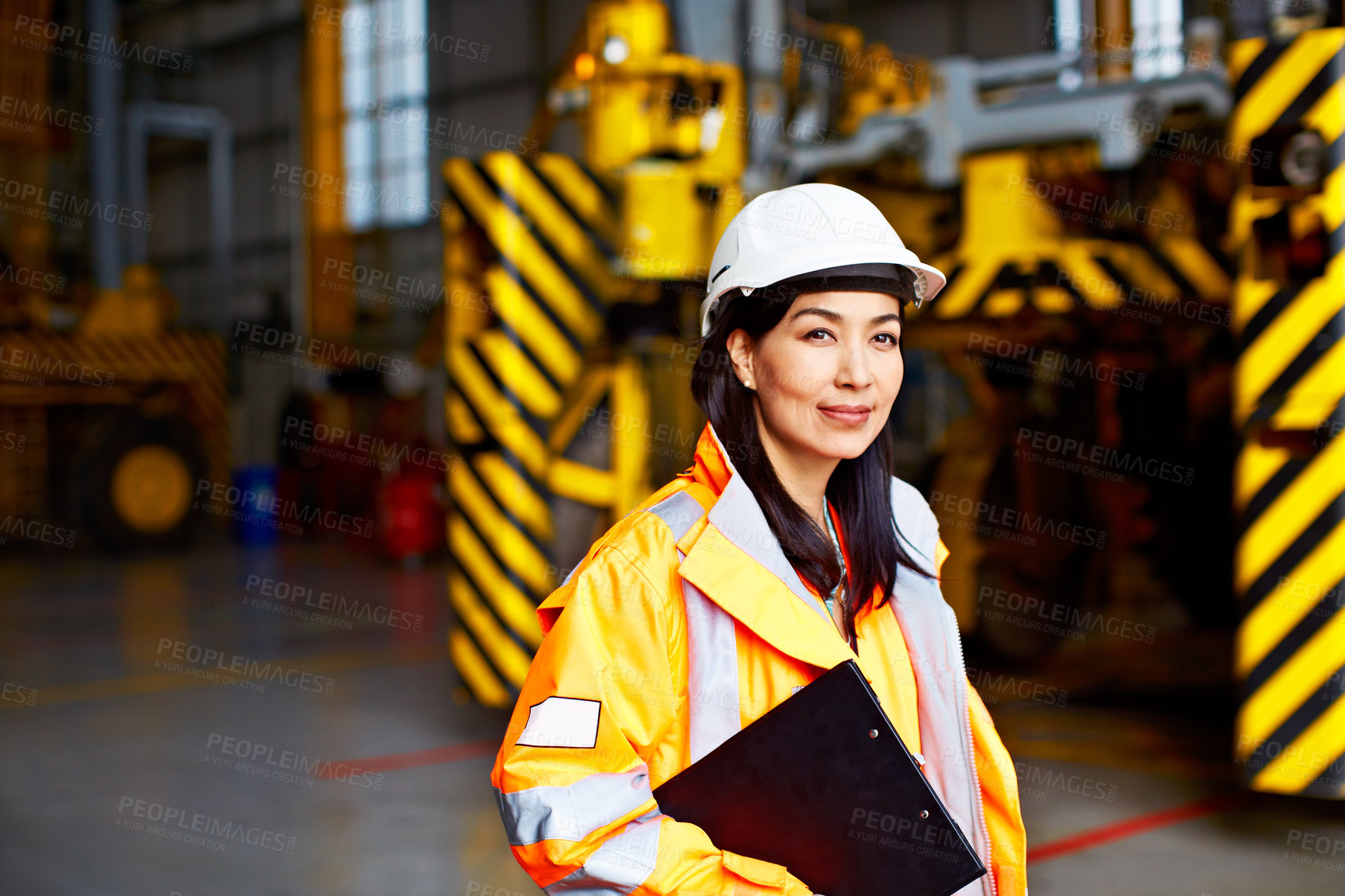 Buy stock photo Portrait of a woman in workwear standing in a large industrial building