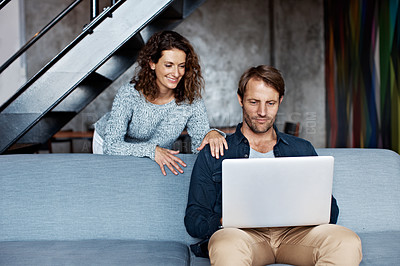 Buy stock photo Shot of a mature couple using a laptop in their living room