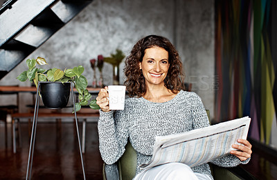 Buy stock photo Portrait of a mature woman sitting in her living room drinking a coffee and reading the newspaper