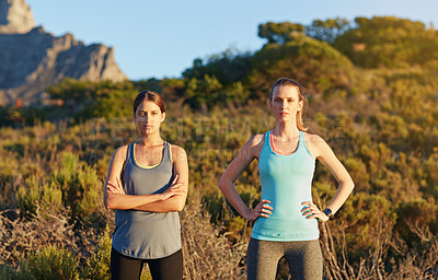 Buy stock photo Portrait of two dedicated young woman out for a cross country run