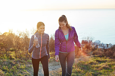 Buy stock photo Shot of two friends talking together while out for a cross country walk