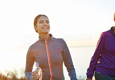 Buy stock photo Shot of two friends talking together after a cross country run