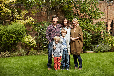Buy stock photo Portrait of a multigenerational family standing in their backyard