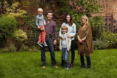 Buy stock photo Portrait of a multigenerational family standing in their backyard