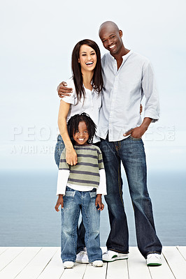 Buy stock photo Portrait of a young family standing outside