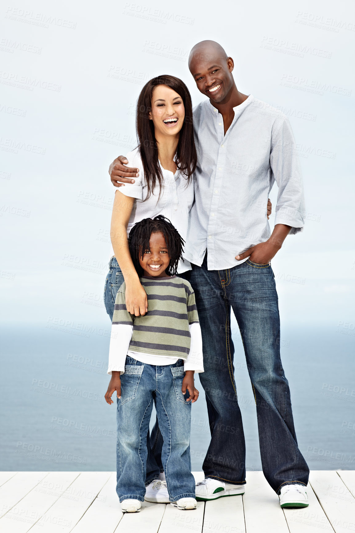 Buy stock photo Portrait of a young family standing outside