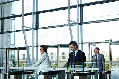 Buy stock photo Shot of businesspeople walking through the lobby of an office building
