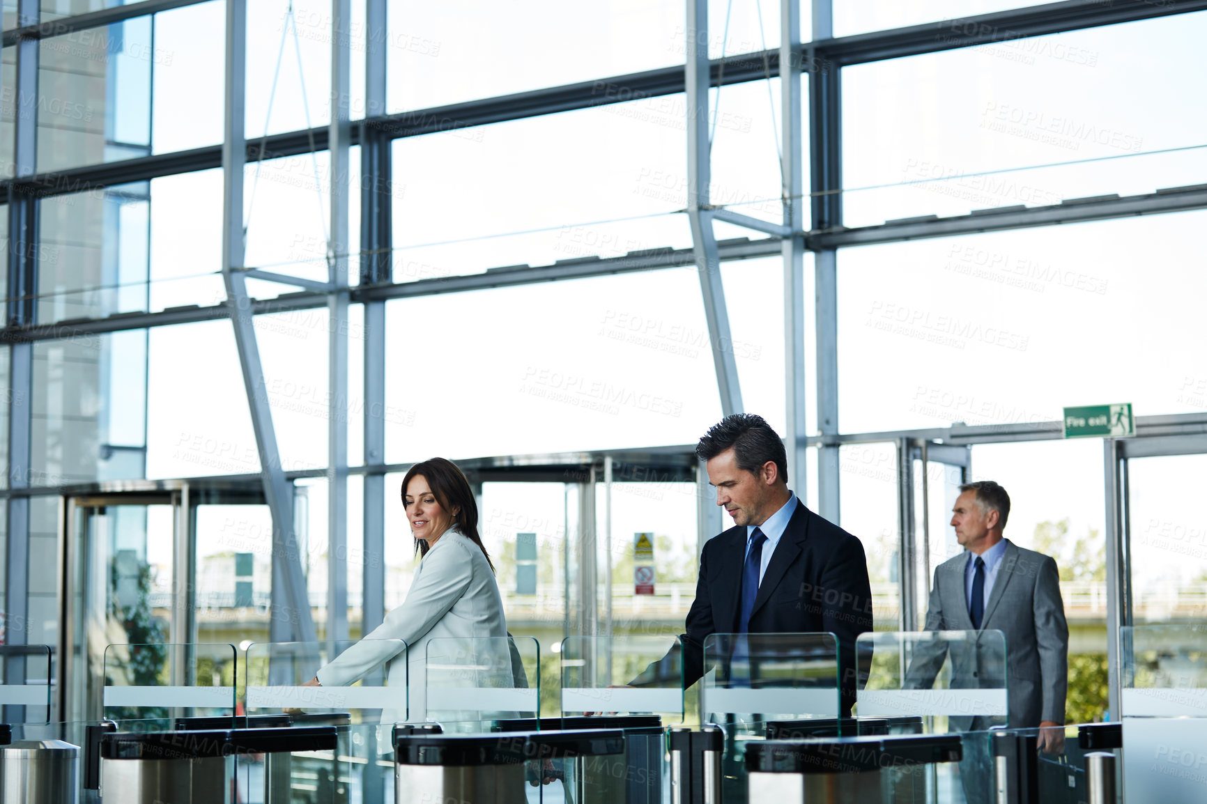 Buy stock photo Shot of businesspeople walking through the lobby of an office building