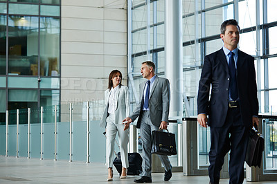 Buy stock photo Shot of businesspeople walking through the lobby of an office building
