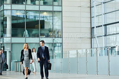 Buy stock photo Shot of businesspeople walking through the lobby of an office building