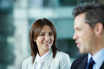 Buy stock photo Shot of businesspeople talking together in the lobby of an office building