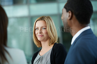 Buy stock photo Shot of businesspeople talking together in the lobby of an office building