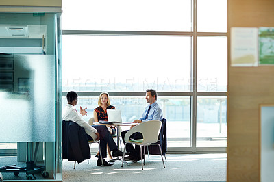 Buy stock photo Shot of a group of businesspeople having a meeting in an office