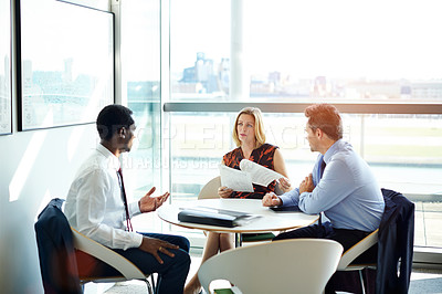 Buy stock photo Shot of a group of businesspeople having a meeting in an office