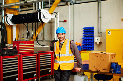 Buy stock photo Portrait of a man in workwear standing by toolboxes in a large industrial building