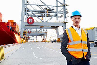 Buy stock photo Portrait of a mature man in workwear standing outside on a large commercial dock