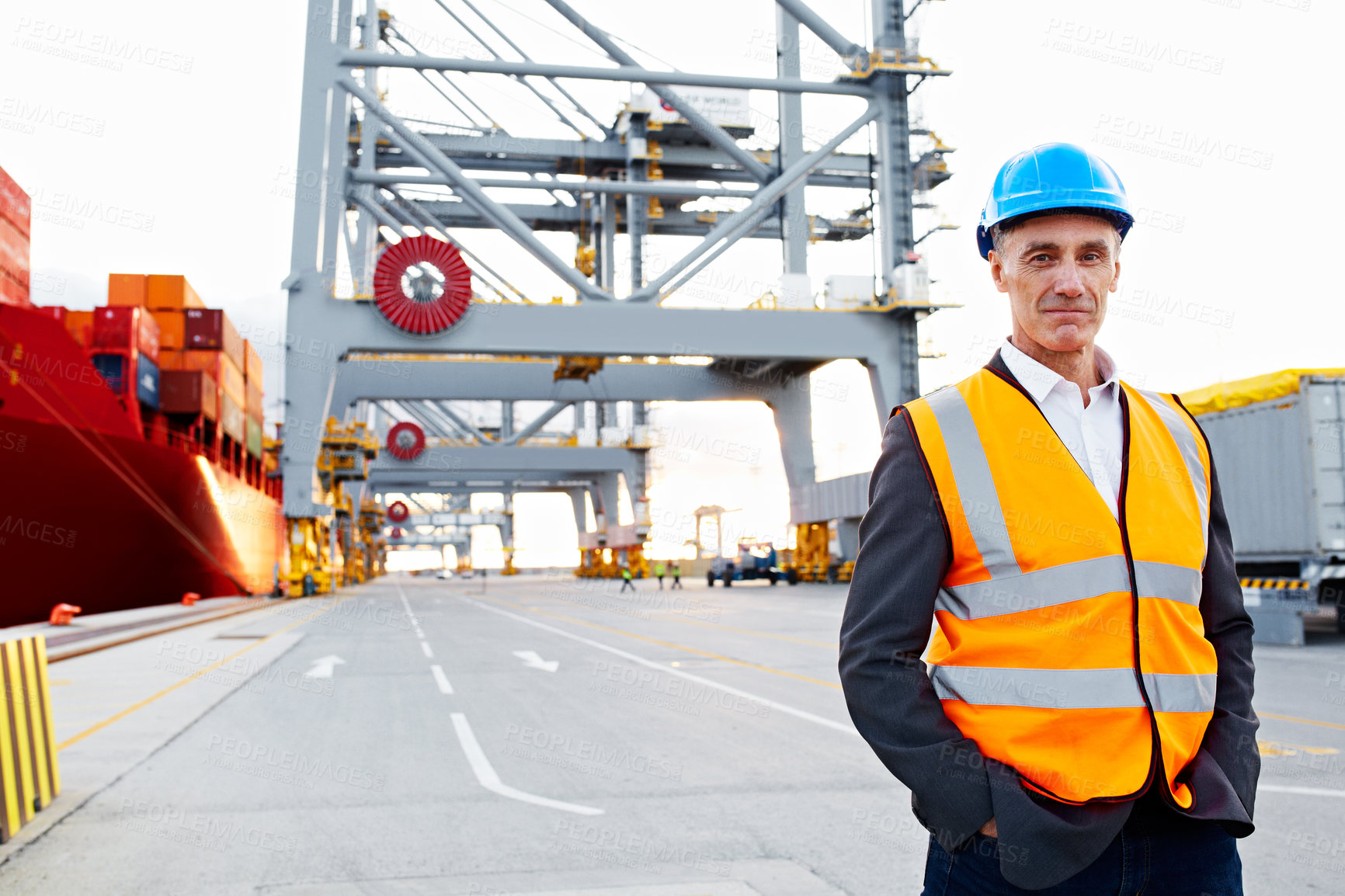 Buy stock photo Portrait of a mature man in workwear standing outside on a large commercial dock