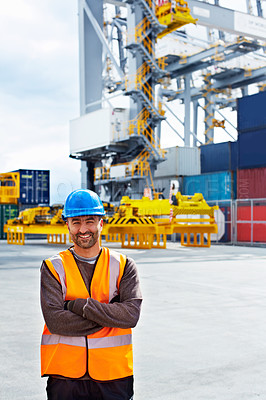 Buy stock photo Portrait of a young man in workwear standing outside on a large commercial dock