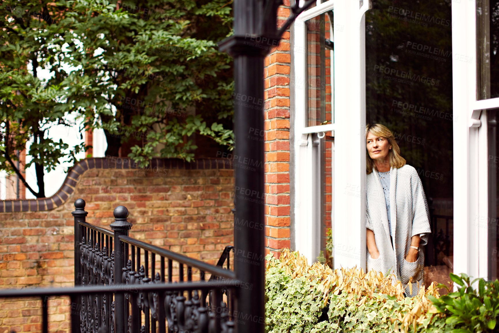 Buy stock photo Morning, thinking and woman by door of holiday home for break, relax or vision and wellness. Daydream, idea and reflection of mature person on terrace of apartment for memories, nostalgia or planning