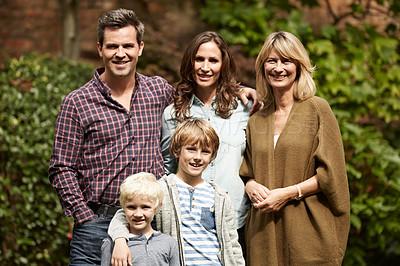Buy stock photo Portrait of a smiling multigenerational family standing together outside