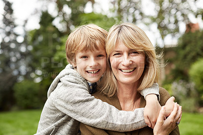Buy stock photo Portrait of a grandmother and her young grandson hugging outside