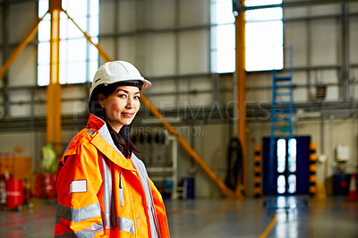 Buy stock photo Portrait of a woman in workwear standing in a large industrial building