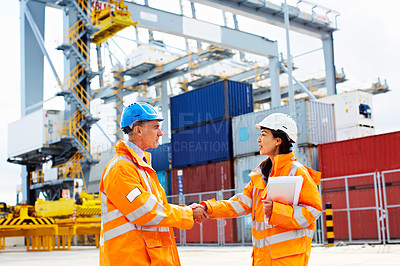 Buy stock photo Portrait of two workers shaking hands on a commercial dock