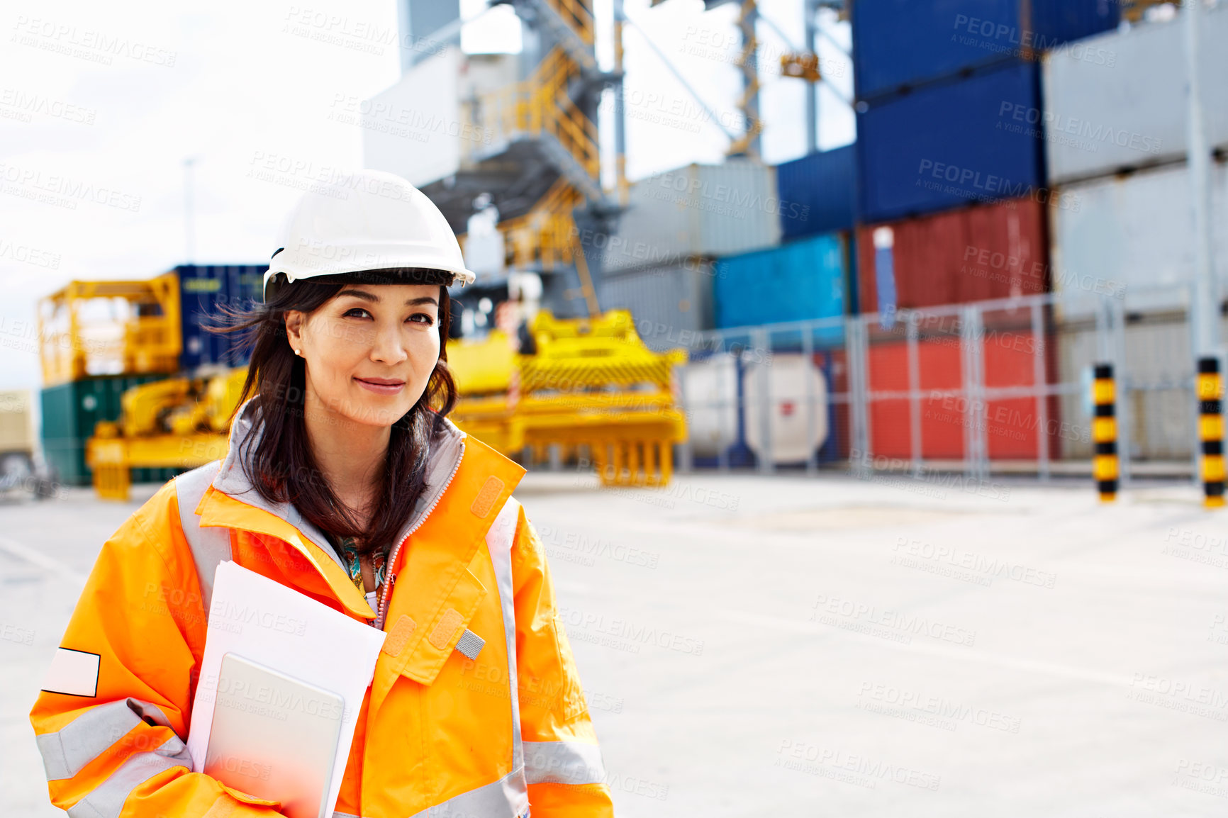 Buy stock photo Portrait of a woman in workwear standing on a commercial dock