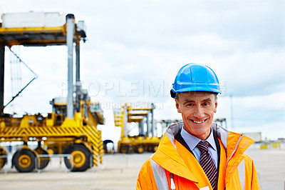 Buy stock photo Portrait of a mature man in workwear standing outside on a large commercial dock