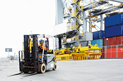Buy stock photo Shot of a forklift operator working on a large commercial dock