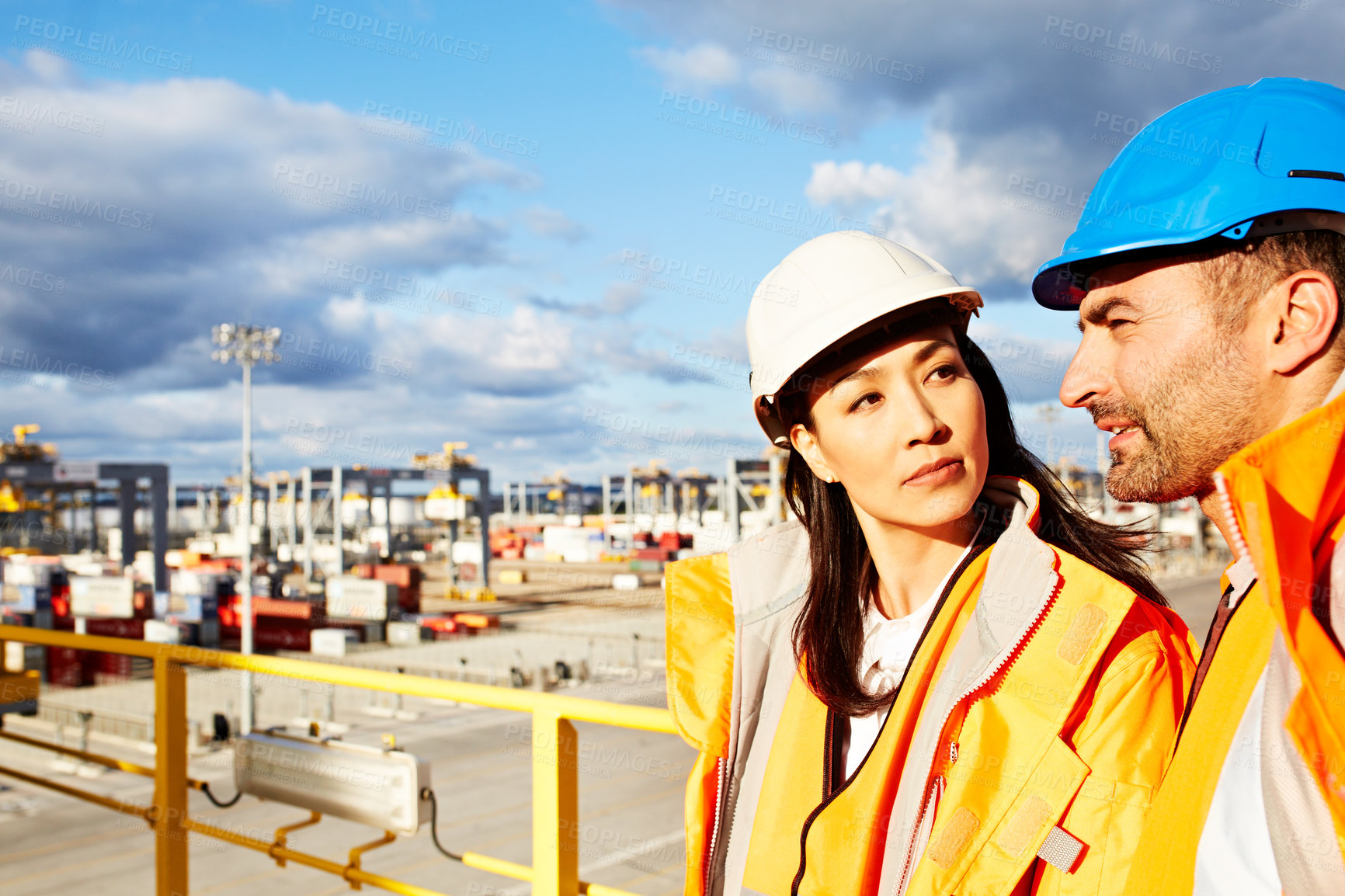 Buy stock photo Shot of a two workers standing on a large commercial dock