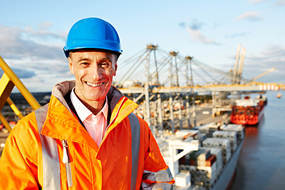 Buy stock photo Portrait of a mature man in workwear standing outside on a large commercial dock
