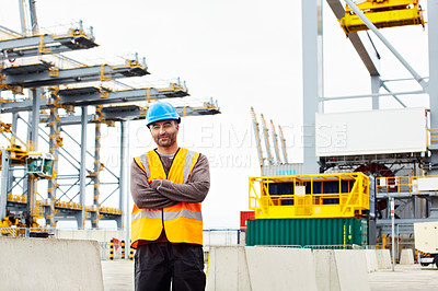 Buy stock photo Portrait of a young man in workwear standing outside on a large commercial dock