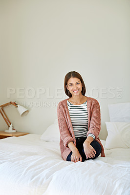Buy stock photo Portrait of a young woman sitting on her bed