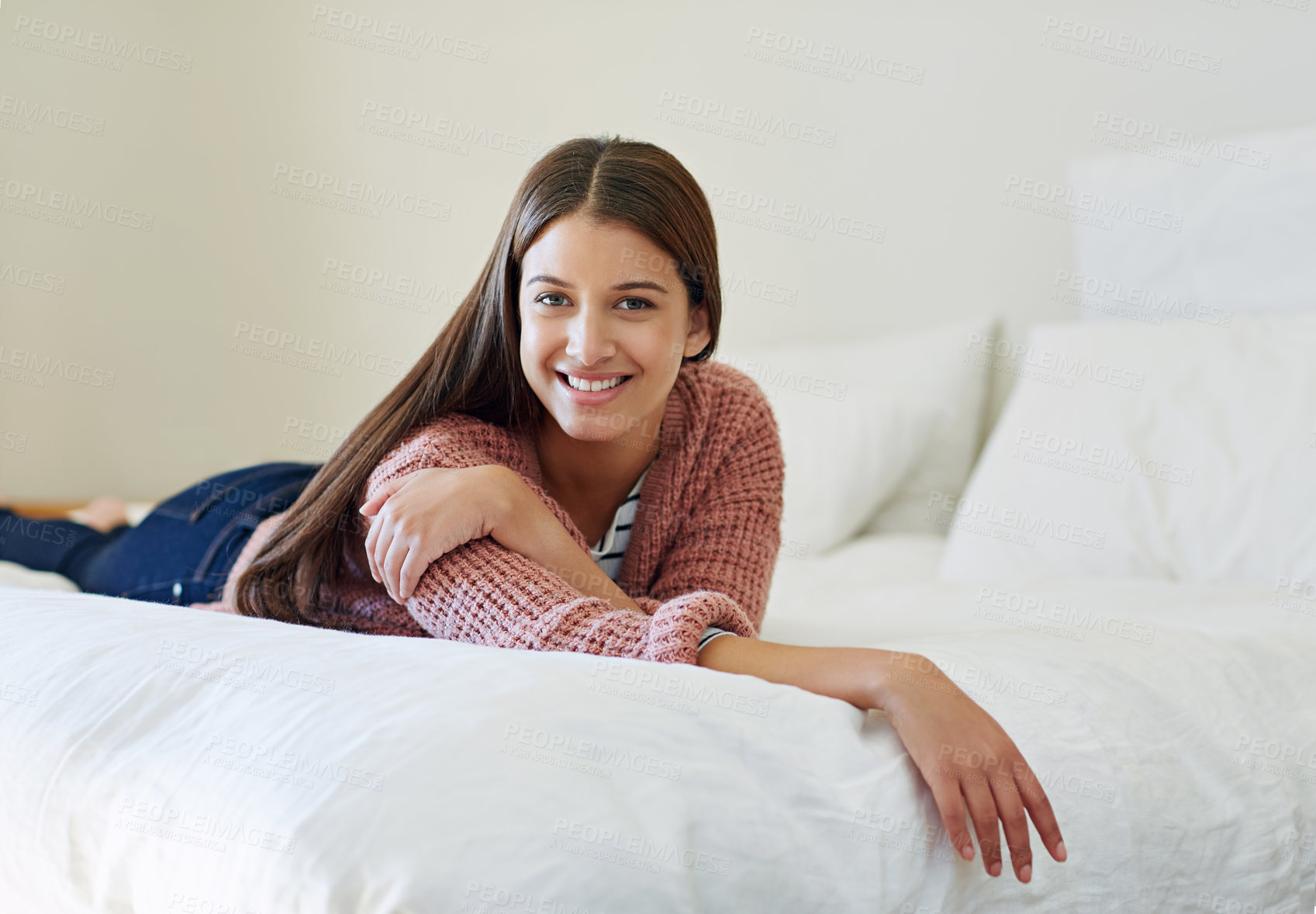 Buy stock photo Portrait of a young woman lying on her bed