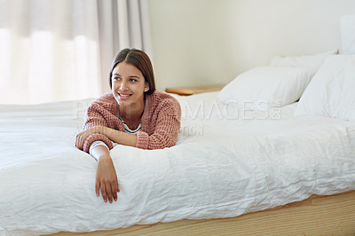 Buy stock photo Portrait of a young woman lying on her bed