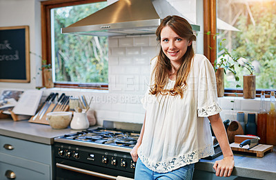 Buy stock photo Portrait of a smiling young woman standing in a kitchen