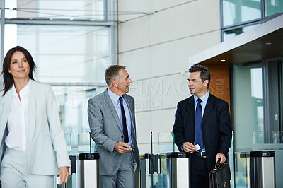 Buy stock photo Shot of businesspeople walking through the lobby of an office building