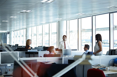 Buy stock photo Shot of a group of businesspeople talking in the office