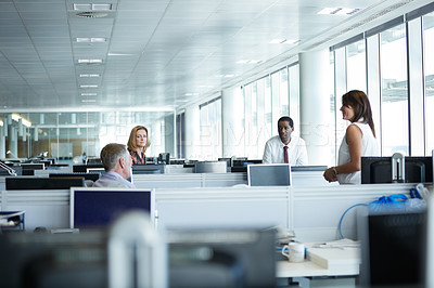 Buy stock photo Shot of a group of businesspeople talking in the office