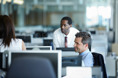 Buy stock photo Shot of a group of businesspeople talking in the office