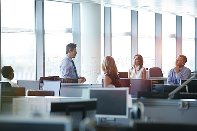 Buy stock photo Shot of a group of businesspeople talking in the office