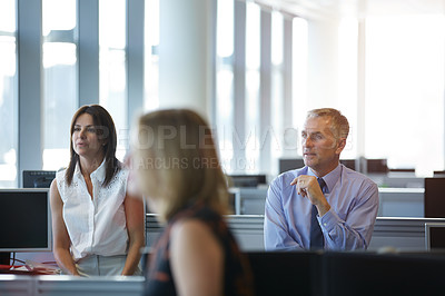 Buy stock photo Shot of a group of businesspeople talking in the office