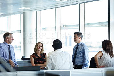 Buy stock photo Shot of a group of businesspeople talking in the office